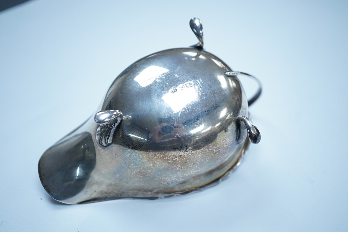 A George V silver sauceboat, by William Neale Ltd, Birmingham, 1925, length 14.6cm, together with a 1950's small silver mug, 6.6oz.